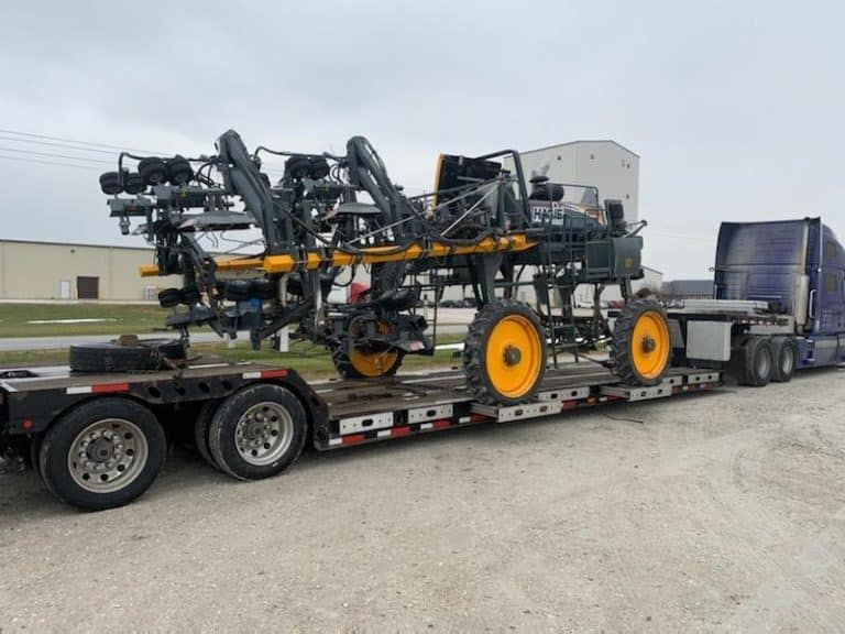 Transporting a 2013 Hagie 204 SP Cutter on a lowboy trailer
