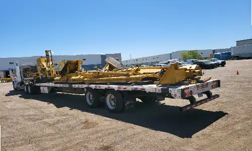 Tractor Transport hauls snow plows