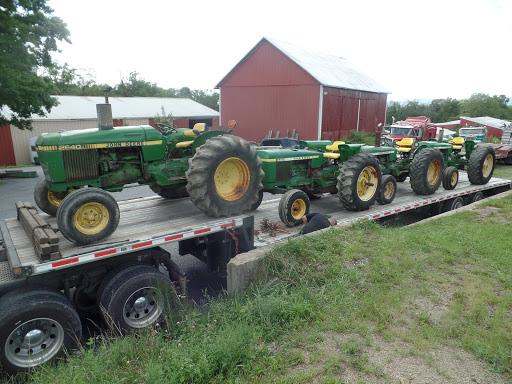  4 John Deere 2640 Tractors being transported